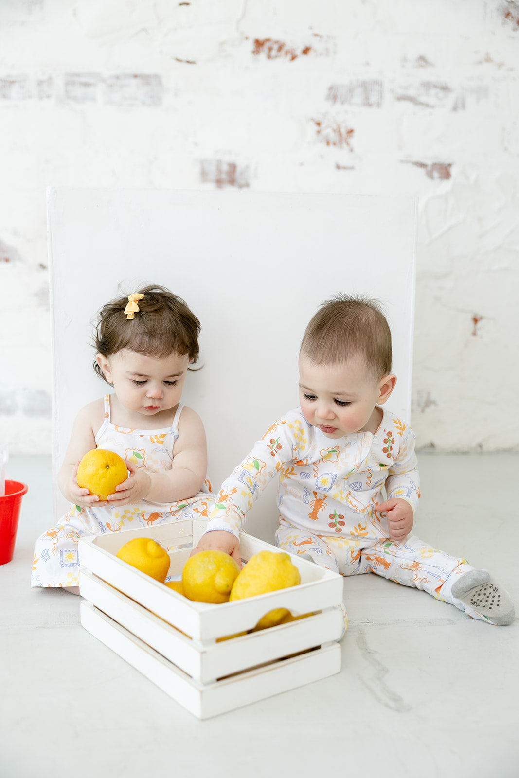 Siblings in matching Bianca & Bear Amalfi Pima cotton dress and sleeper