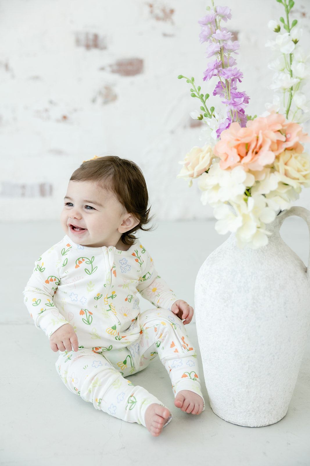 Baby wearing Bianca & Bear Floral Pima cotton zipper sleeper